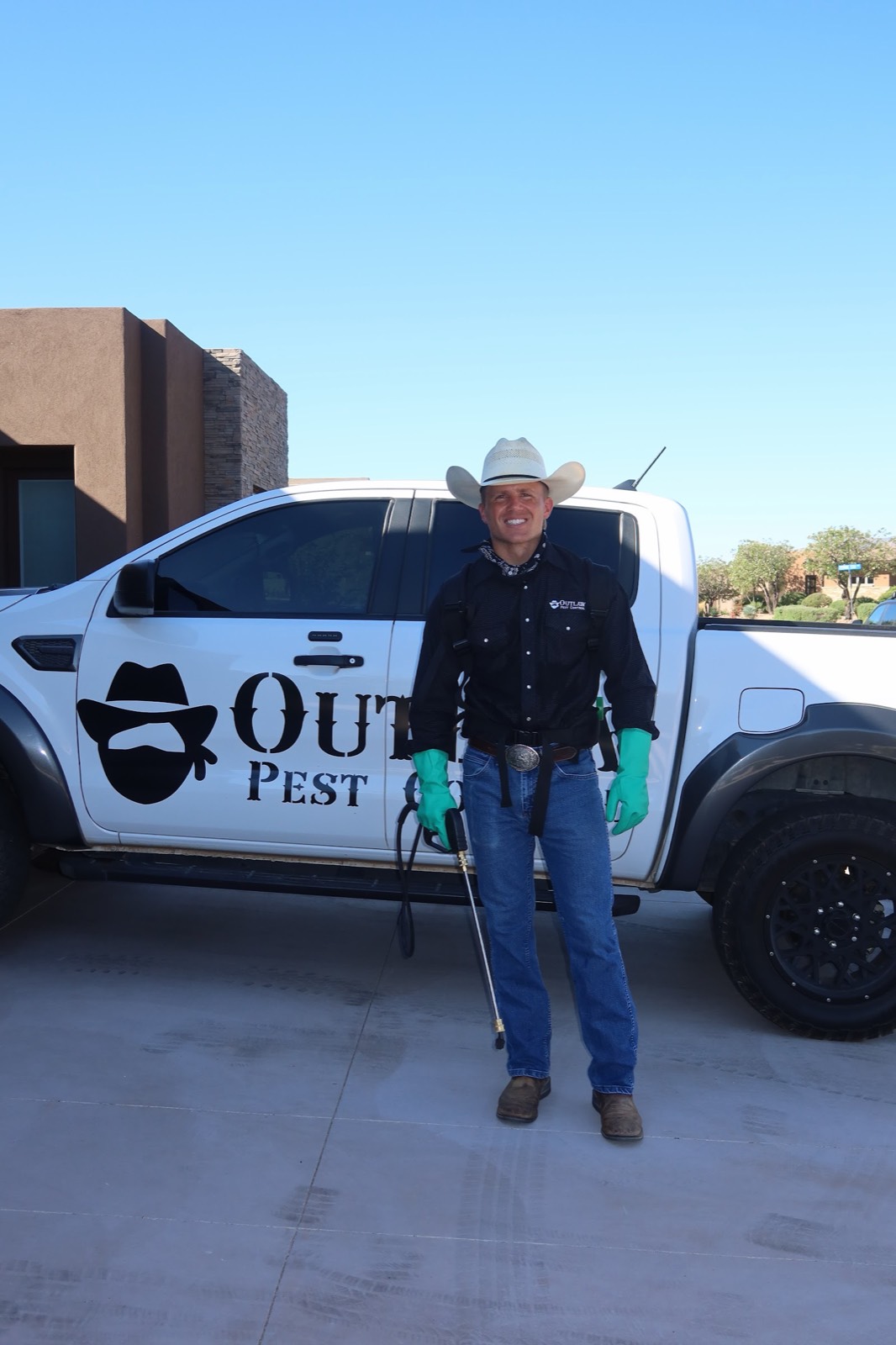 Outlaw Pest Control technician beside the company truck in St. George, Utah